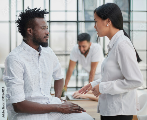 Business Handshake - business people shaking hands. Handshake between business man and woman indoors.