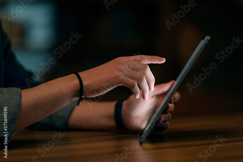 Male hands touching digital pad pc screen, using gadget at night