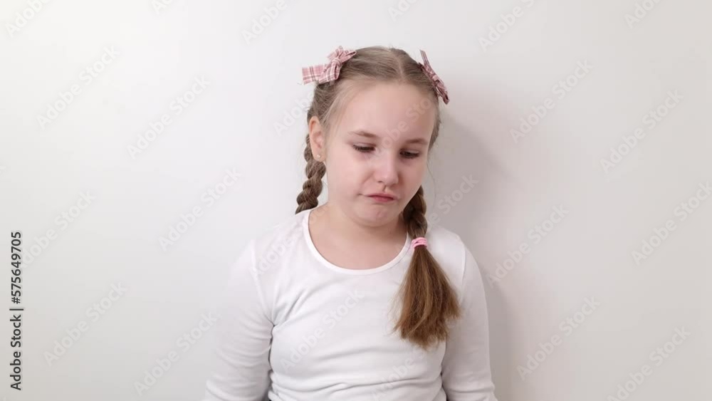 Angry little girl throws plush toy. Small kid showing negative emotions throwing teddy bear. Annoyed and upset child. Frustration, anger, rage and mischief concepts