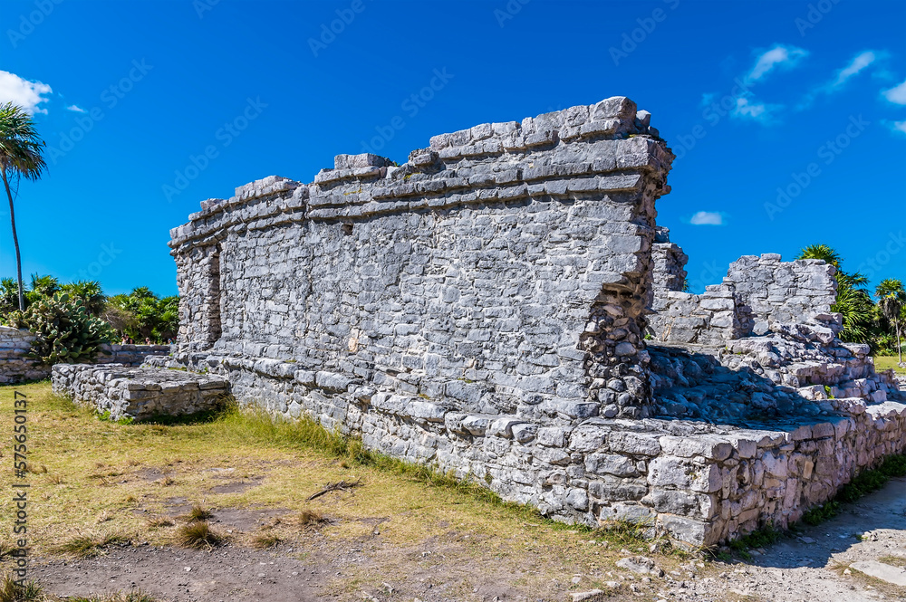 A view of a building ruin at the Mayan settlement of Tulum, Mexico on a sunny day