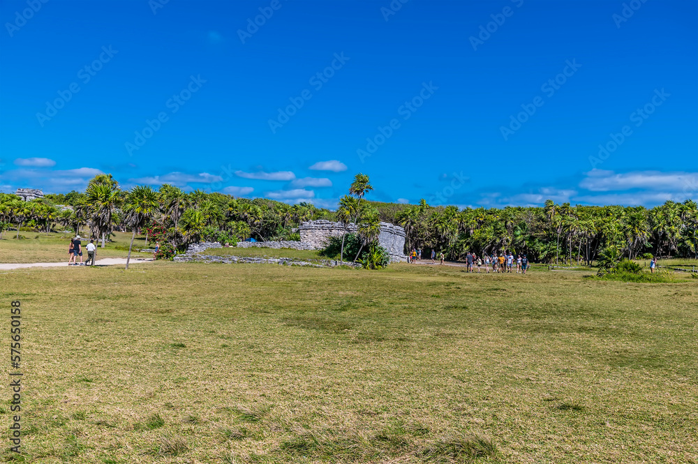A view towards the entrance of the Mayan settlement of Tulum, Mexico on a sunny day