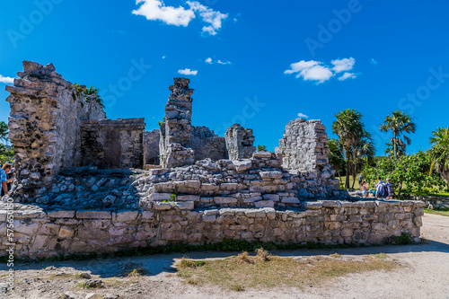 A view of ancient building ruins at the Mayan settlement of Tulum, Mexico on a sunny day