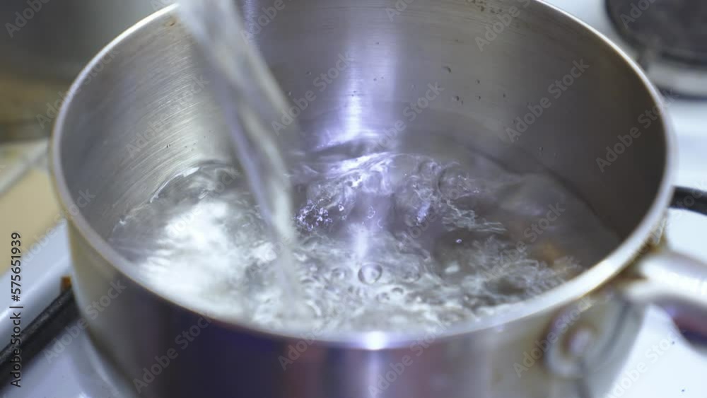 water is poured for a boiling in pot on a gas stove. water is poured for a boiling in pot on a gas stove.