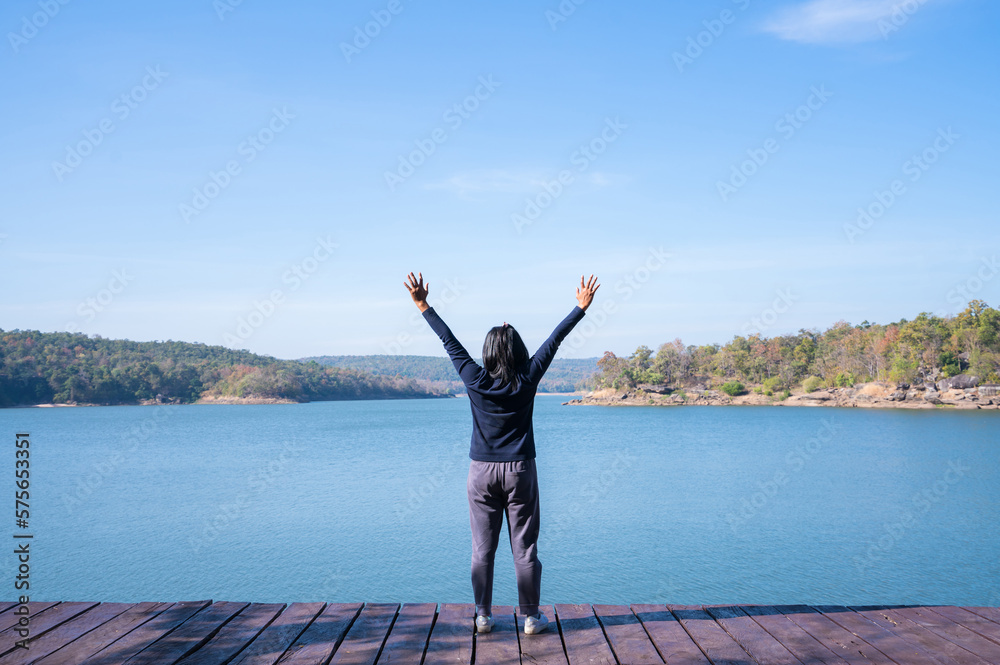Happy young woman enjoying at mountain lake. Happy young woman enjoying at mountain lake.