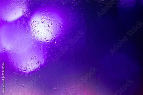 Bokeh lights through a wet window.