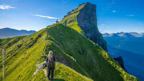 Der Lechtturm Kallur auf der Färör Insel Kalsoy steht einsam auf einer Landzuge über dem Meer und ist ein lohnenswertes Ziel für Wanderer. Das Panorama  von den steilen Klippen ist beeindruckend. photo