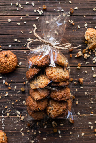 Healthy cookies in transparent packaging. Delicious oatmeal buiscuit on the wooden background.