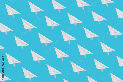 Pattern made of paper planes on pastel blue background.