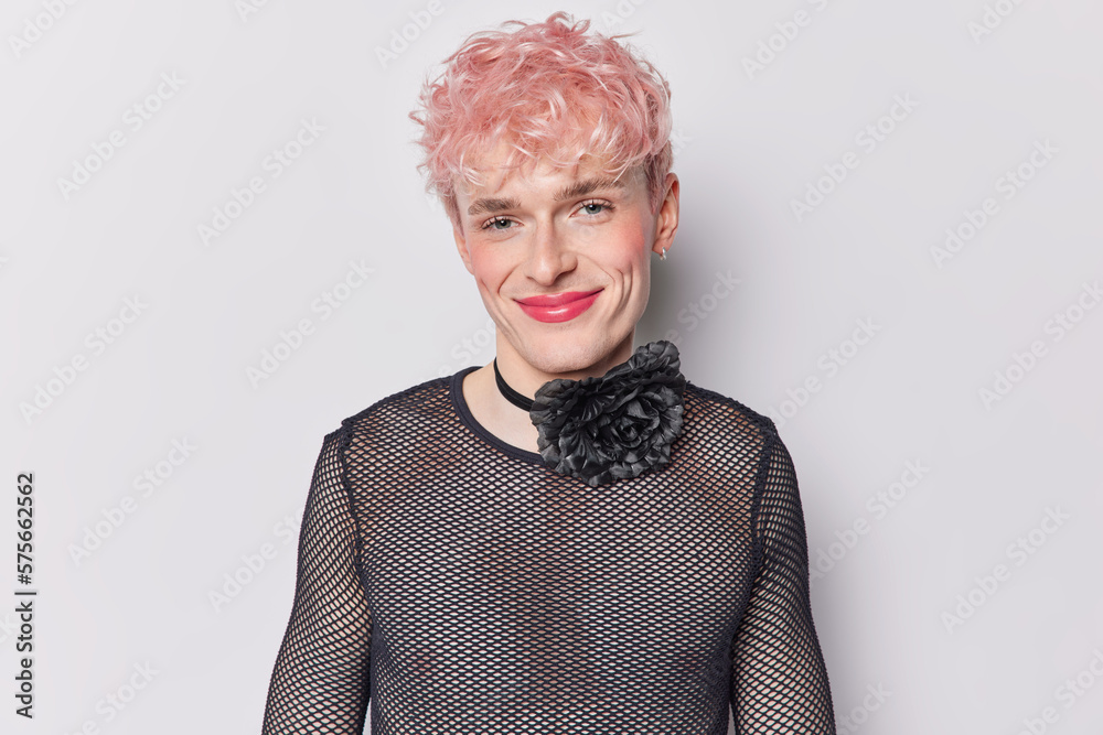 © wayhome.studio - Portrait of pink haired gay man wears makeup and lipstick wears black net shirt smiles pleasantly happy with his gender identity isolated on white background. Transgender woman changed sex after birth © wayhome.studio - Portrait of pink haired gay man wears makeup and lipstick wears black net shirt smiles pleasantly happy with his gender identity isolated on white background. Transgender woman changed sex after birth