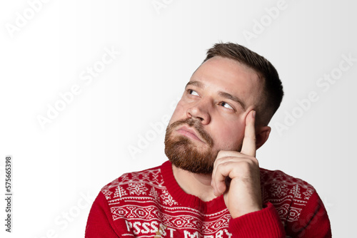 Young, bearded man thinking about something. Isolated on white, copy space