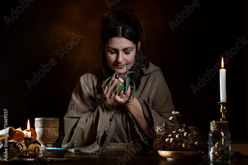 Herb woman in the Middle Ages smells herbs