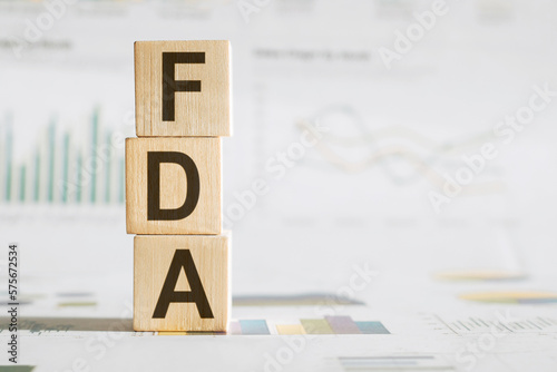 FDA written on wooden cube with chart. Business concept