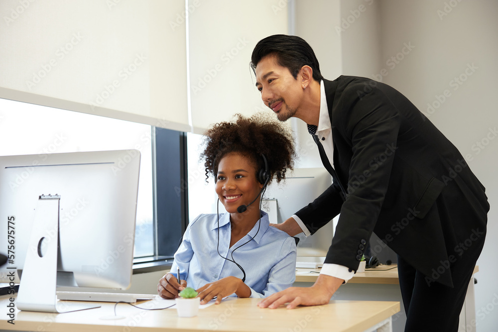 businessman or supervisor training and suggesting about work to colleagues at call center service in the office businessman or supervisor training and suggesting about work to colleagues at call center service in the office