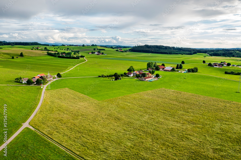 Naklejka premium Amazing wide aerial view from drone of beautiful green countryside, fields, road, and farms.
