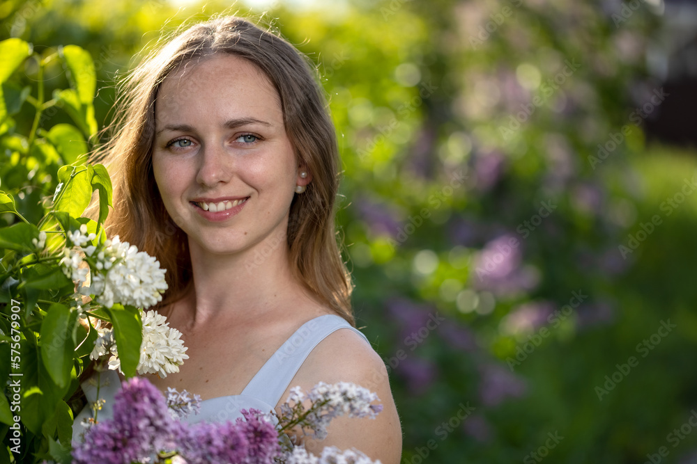 Portrait Girl with Flowers Lilac in the Garden in Spring Portrait Girl with Flowers Lilac in the Garden in Spring