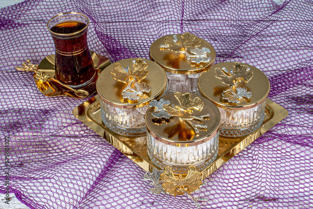 Delicious Turkish delight and candies served with tea in glass bowls.Almond candies. Sugar Feast, (Feast of Ramadan) Ramadan concepts. Delicious Turkish delight and candies served with tea in glass bowls.Almond candies. Sugar Feast, (Feast of Ramadan) Ramadan concepts.