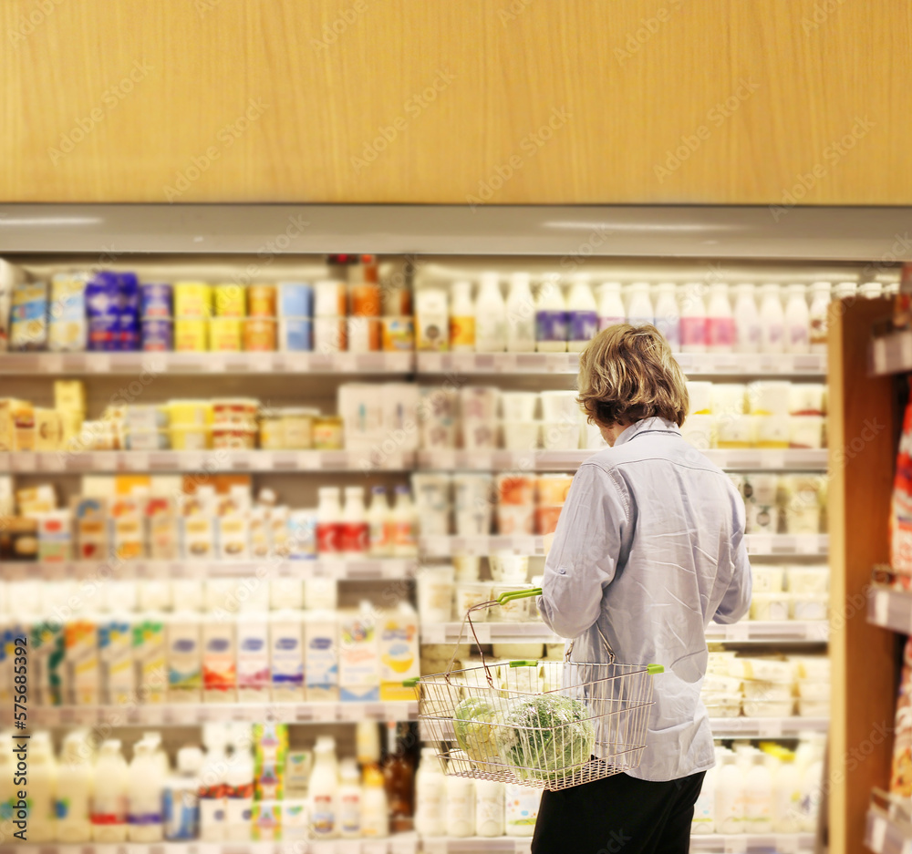 man choosing a dairy products at supermarket.