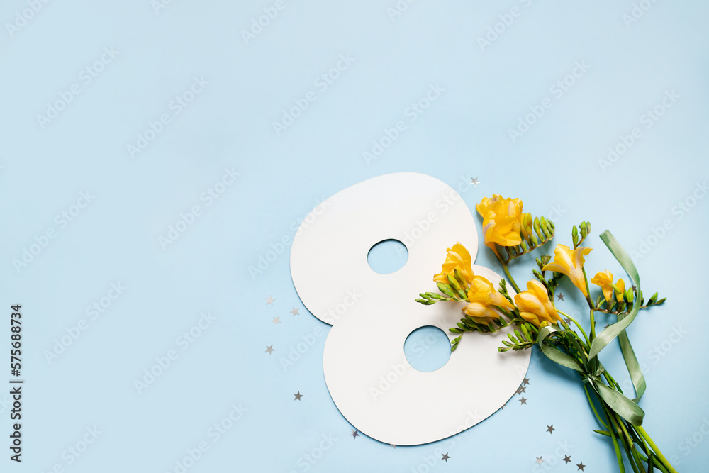 
number 8 shape layout with yellow flowers bouquet on blue background. copy space. top view. concept of international women's day. March 8. - obrazy, fototapety, plakaty 