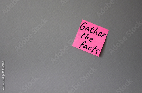 Gather the facts symbol. Concept words Gather the facts on pink steaky note. Beautiful grey background. Business and Gather the facts concept. Copy space.