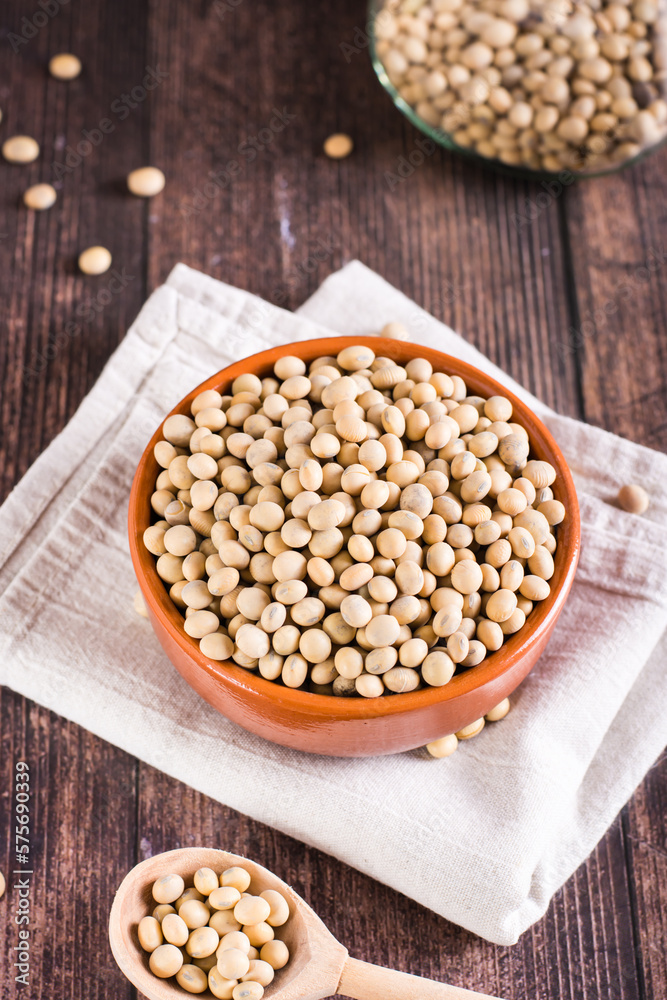 Ripe soybeans in a bowl and spoon on the table. Vegetable protein and antioxidant. Vertical view Ripe soybeans in a bowl and spoon on the table. Vegetable protein and antioxidant. Vertical view