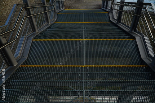 Metal stair flights with yellow stripes perspective view from above