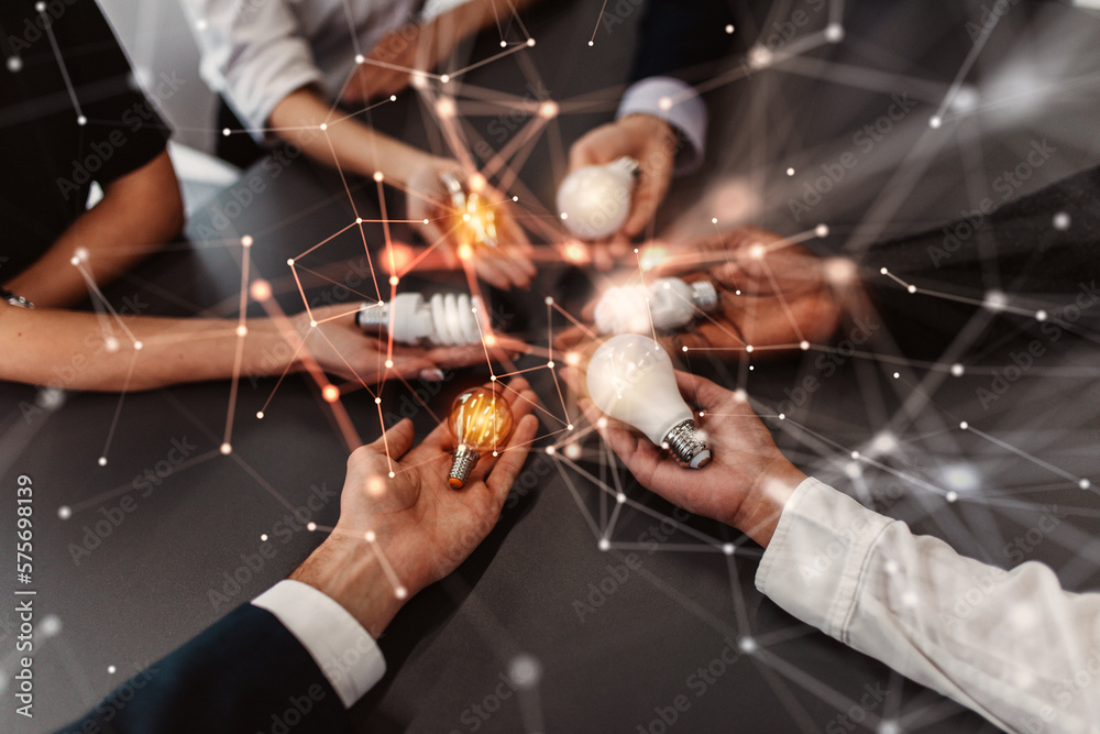 Fototapeta premium Teamwork and brainstorming concept with businessmen that share an idea with a lamp