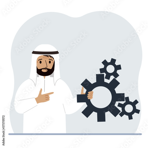 A man holds gears in his hand. Points a finger at the cogwheels. The concept of financial planning, movement, life, education or maintenance.