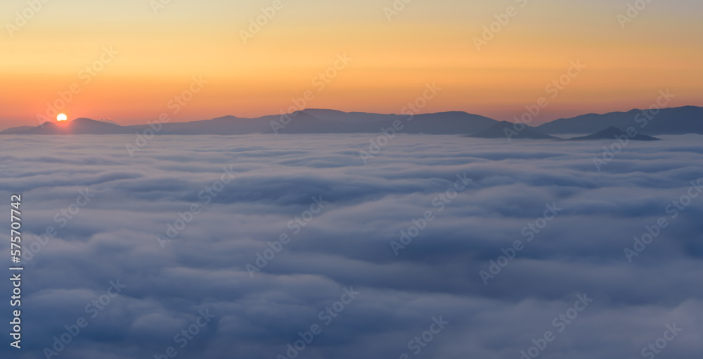 Cloud inversion above the CHKO Ceske Stredohori in Czechia during autumn sunset.