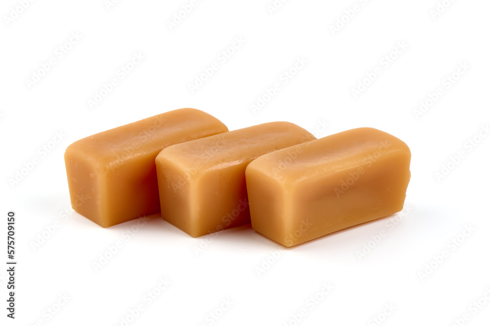 Caramel candies with caramel sauce, isolated on white background. Caramel candies with caramel sauce, isolated on white background.