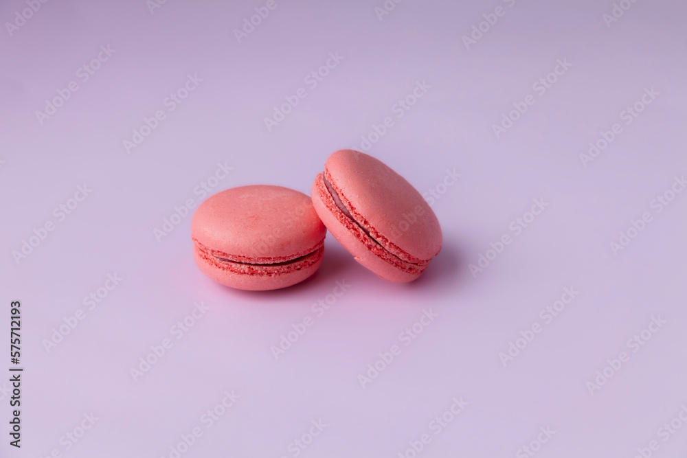 Two pink macaroons on pink background close up copy space Two pink macaroons on pink background close up copy space