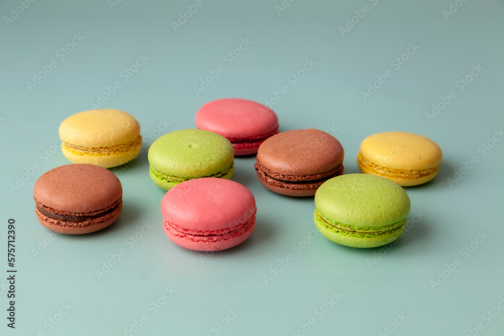 Multi color macaroons on turquoise background close up Multi color macaroons on turquoise background close up