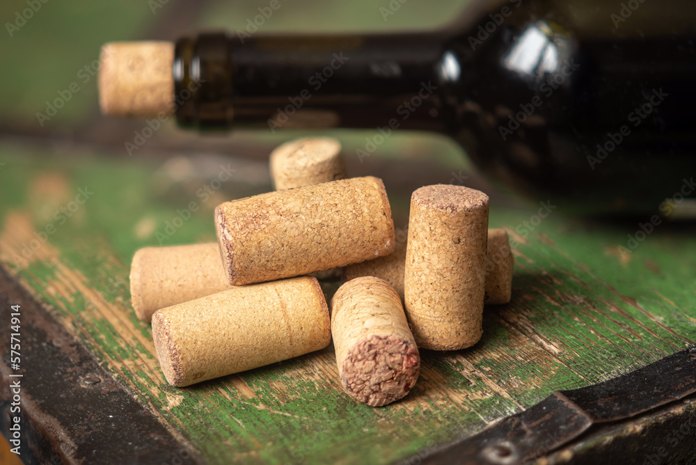 Corks from wine bottles on a wooden table.