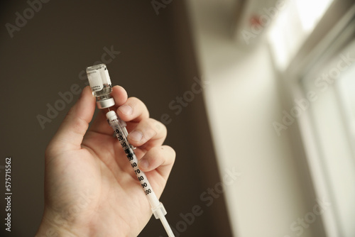 flu vaccine and needle syringes showing opioid crisis needle therapy and virus