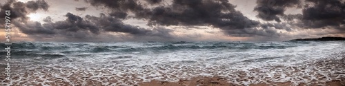 Sandy deserted beach with ocean waves on the shore. Skies and water meet on the horizon by generative AI