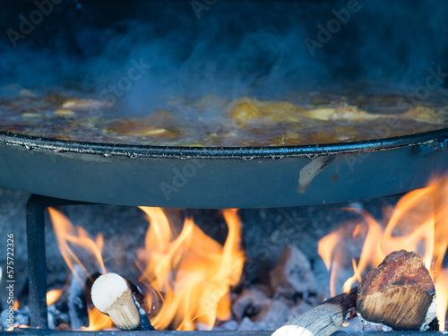 cooking Valencian paella with firewood