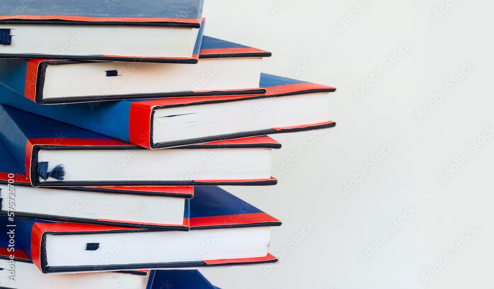 Hard cover books stacked on white surface with copy space,education concept Hard cover books stacked on white surface with copy space,education concept