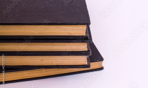 Hard cover old books stacked on white with copy space,top view,education concept