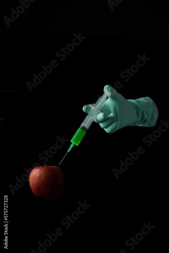 Injection of poison into a genetically modified apple