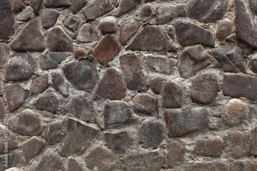Stone wall background. The wall is ancient. Stone texture. River stone