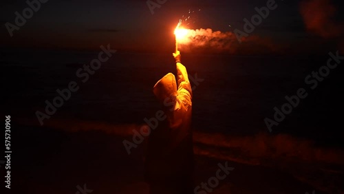 a lonely traveler in distress, shipwreck victim signal light at night help signal ocean at night