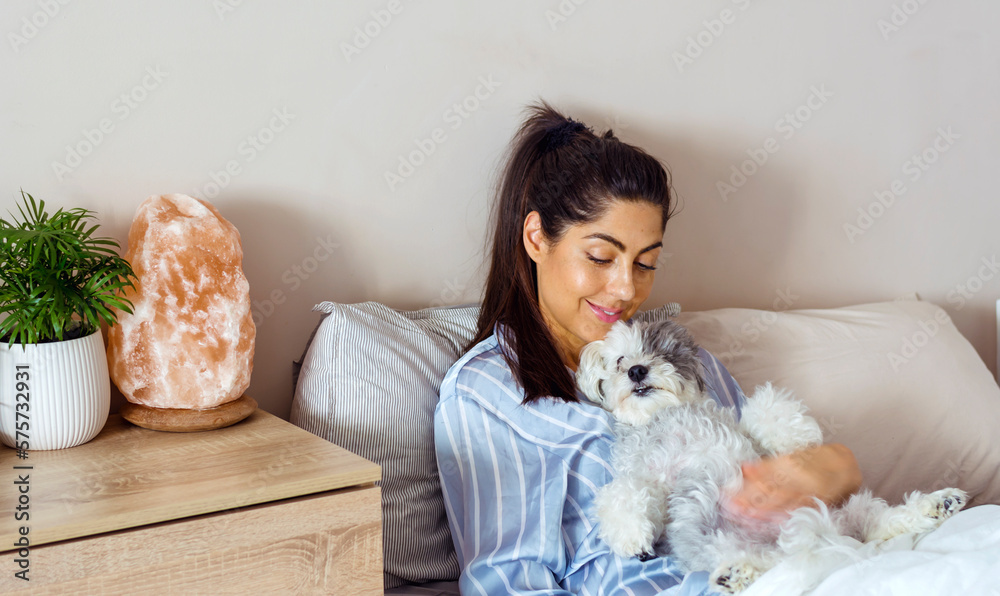 Woman Hugging her Sleeping Dog in her Bed Woman Hugging her Sleeping Dog in her Bed