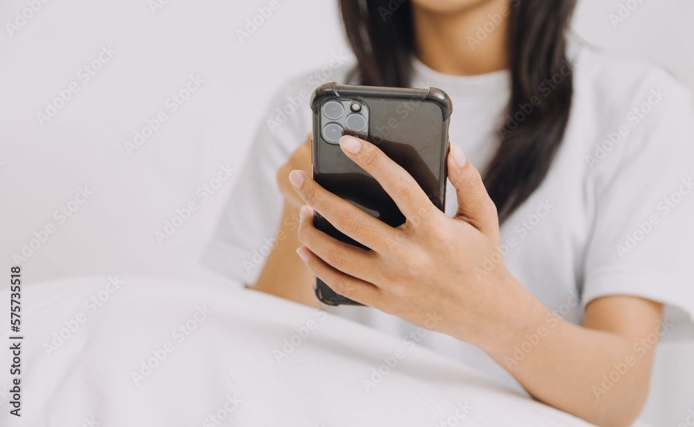 Efficient Young Millennial Girl Sitting on a Bed in the Morning, Uses Laptop Computer and Eats Croissants and Drinks Coffee for Breakfast. Top Down Shot. Efficient Young Millennial Girl Sitting on a Bed in the Morning, Uses Laptop Computer and Eats Croissants and Drinks Coffee for Breakfast. Top Down Shot.