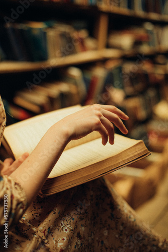 person reading a book in a library
