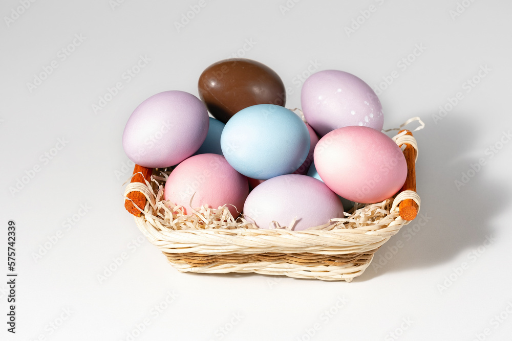 Basket with easter eggs on white background Basket with easter eggs on white background
