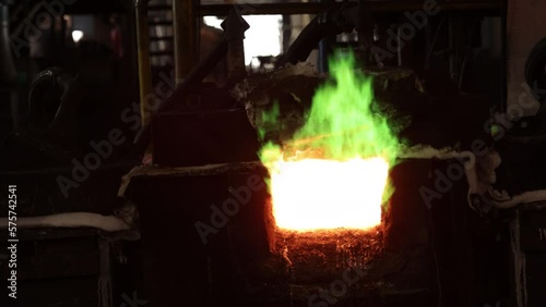 metallurgical plant, Bright flames, Molten copper. Intense heat and bright flames accompanying smelting of copper at metallurgical plant. Copper is produced through evaporation of gases. photo