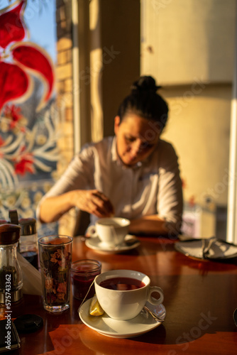 Middle age woman drinking tea at the restaurant