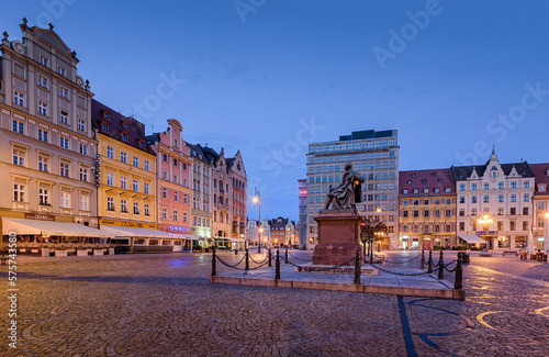 Side view of the market square in Wroclaw with colorful buildings and statue of Alexander Fredro