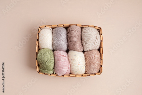 Craft knitting hobby background with yarn in natural colors. Recomforting hobby to reduce stress for cold fall and winter weather. Mock up, copy space, top view photo