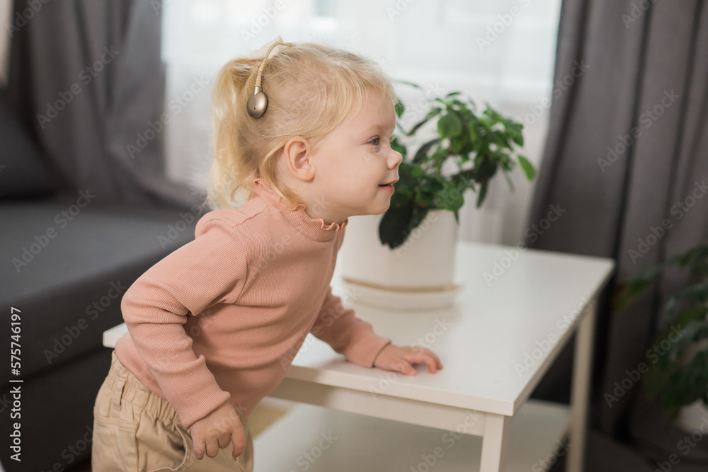 Cochlear implant system. Installation cochlear implant on child girl ear for restores hearing. Kid hears after hear return to normal Cochlear implant system. Installation cochlear implant on child girl ear for restores hearing. Kid hears after hear return to normal