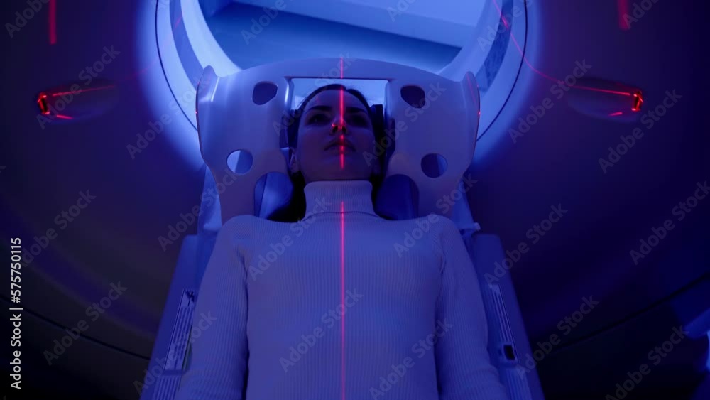 4k video CT x-ray examination of lung cancer with red lines and blue light in medical clinic. Patient girl lies on computed tomography bed and scanning lungs for diagnose lung cancer. 4k video CT x-ray examination of lung cancer with red lines and blue light in medical clinic. Patient girl lies on computed tomography bed and scanning lungs for diagnose lung cancer.
